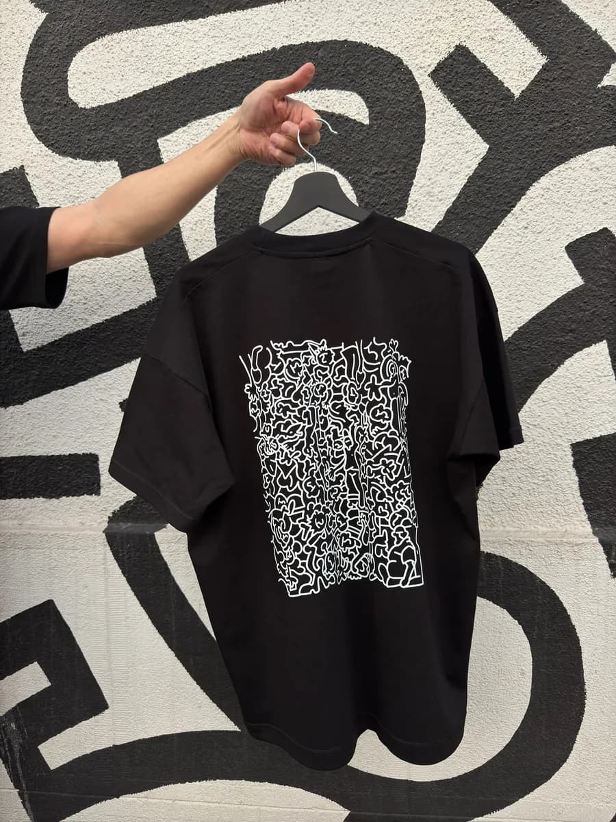 Black oversize t-shirt with a large white DTF line-art print on the back
