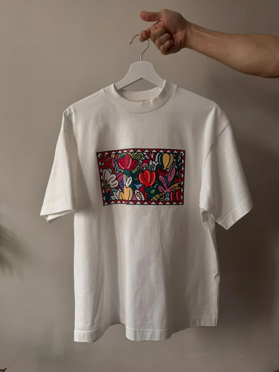 White t-shirt on a hanger with a colourful floral DTF print