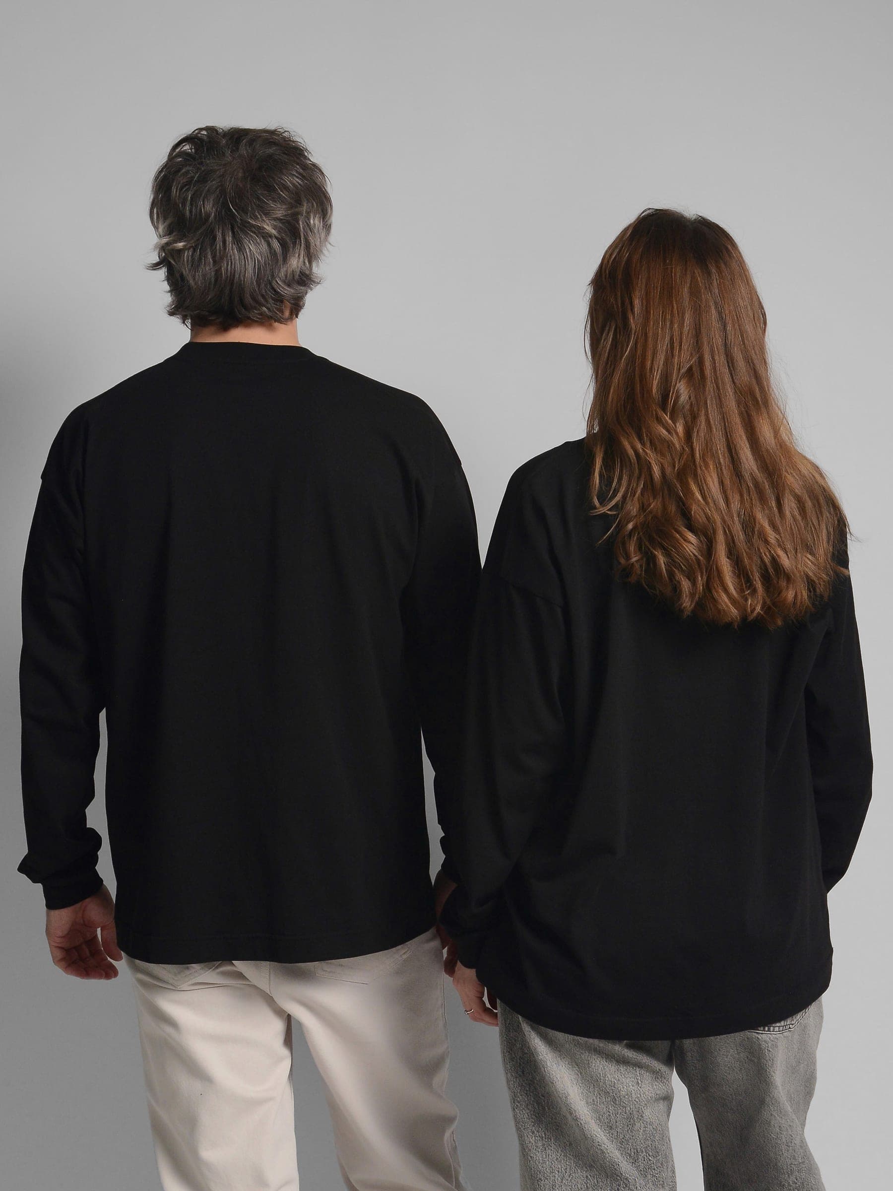 365.APParel Basic Longsleeve Black — couple in matching basics, full body back view, side by side, studio
