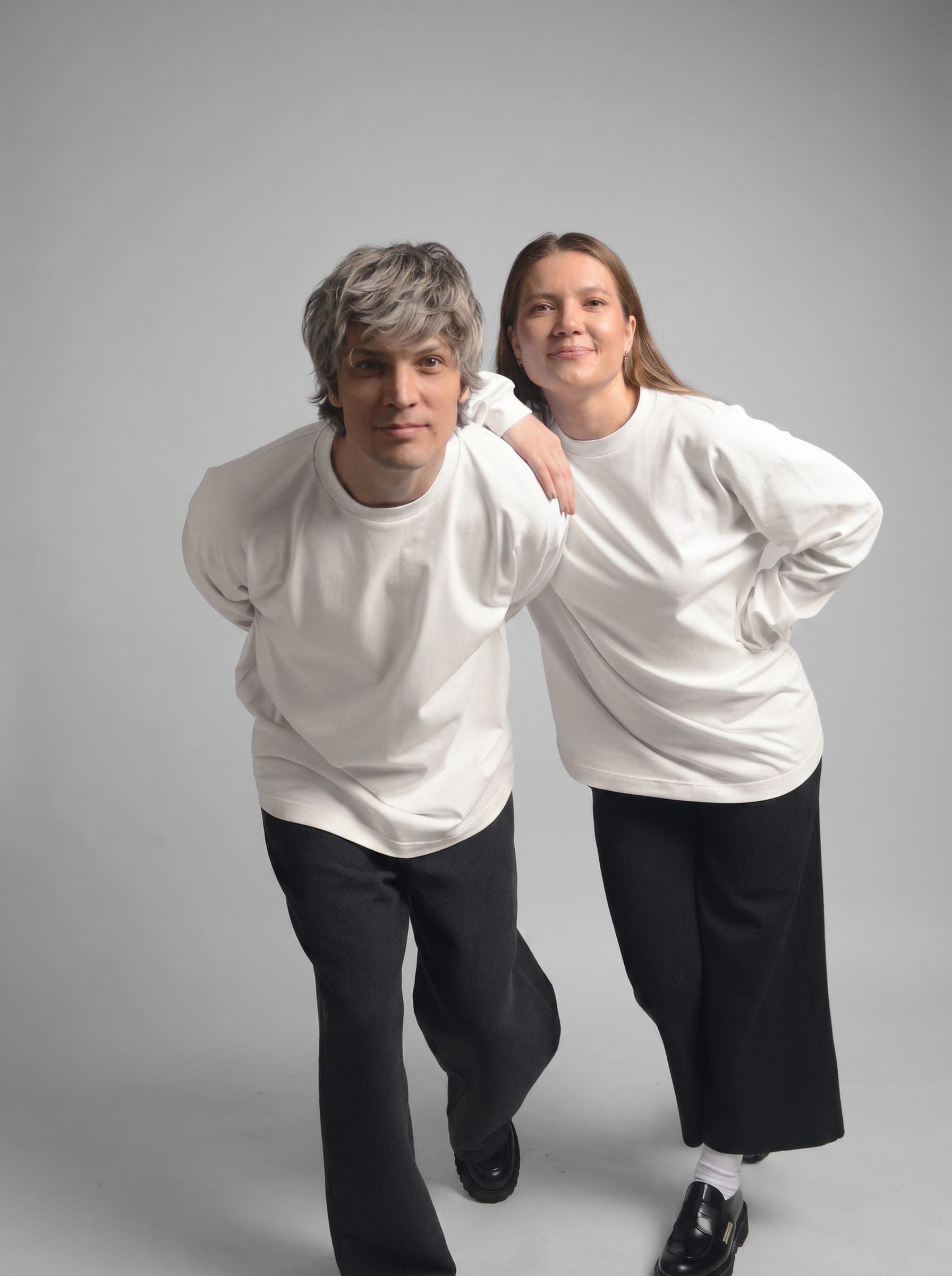 365.APParel Basic Longsleeve Off White — couple in matching basics, cropped front view, leaning together, studio