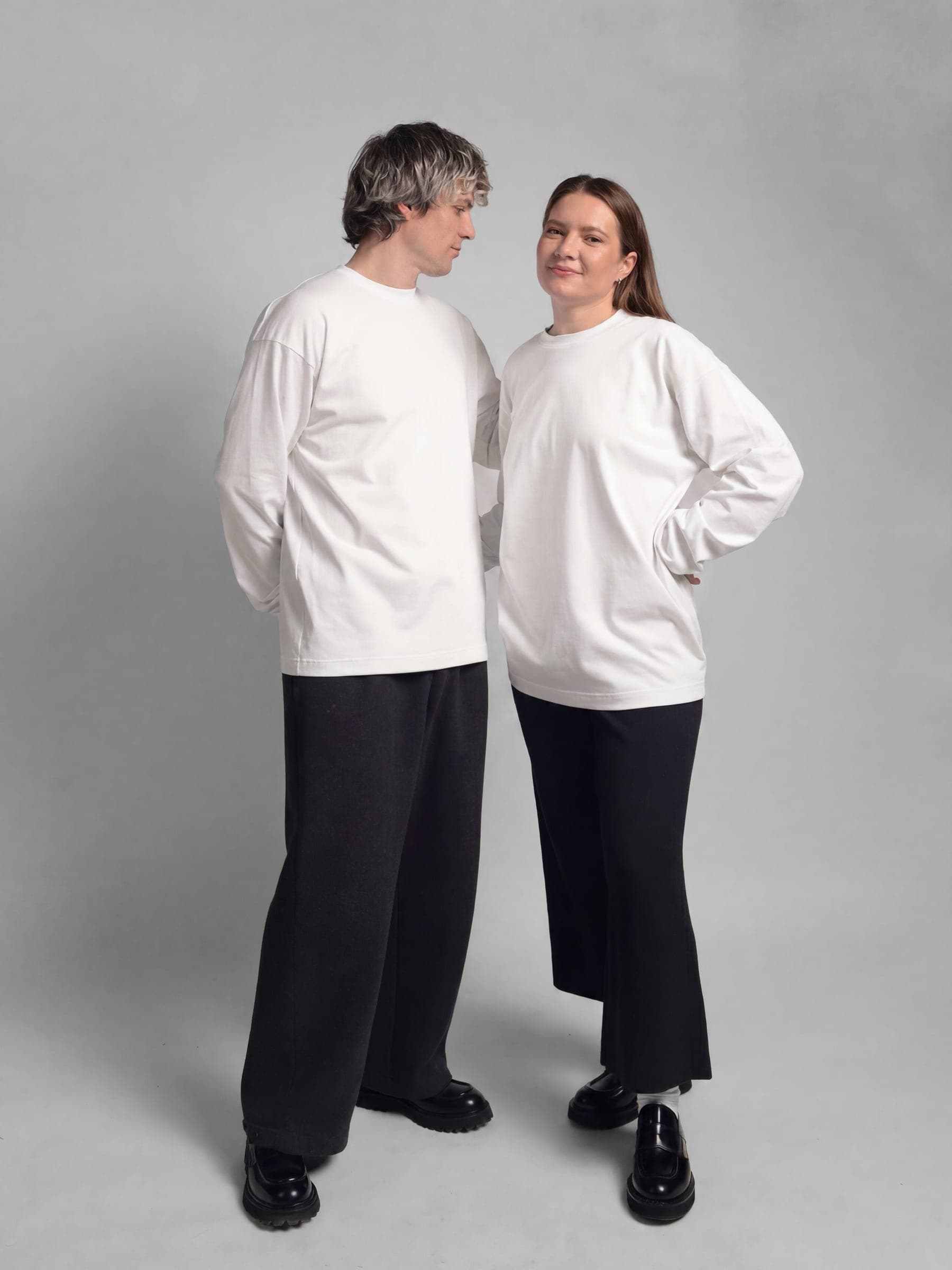 365.APParel Basic Longsleeve Off White — couple in matching basics, full body, looking at each other, studio