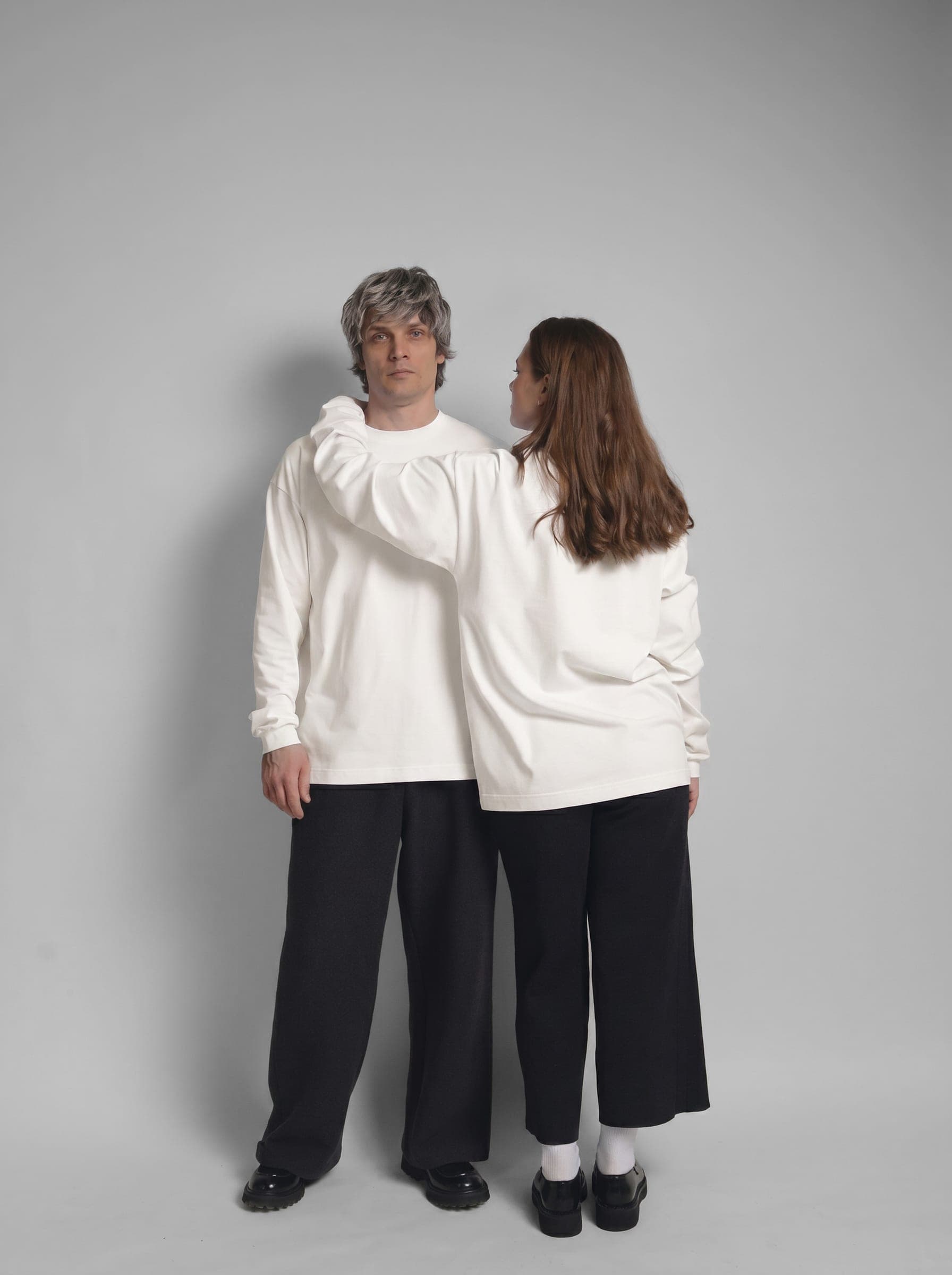 365.APParel Basic Longsleeve Off White — couple in matching basics, woman facing away, hand on man's shoulder, studio