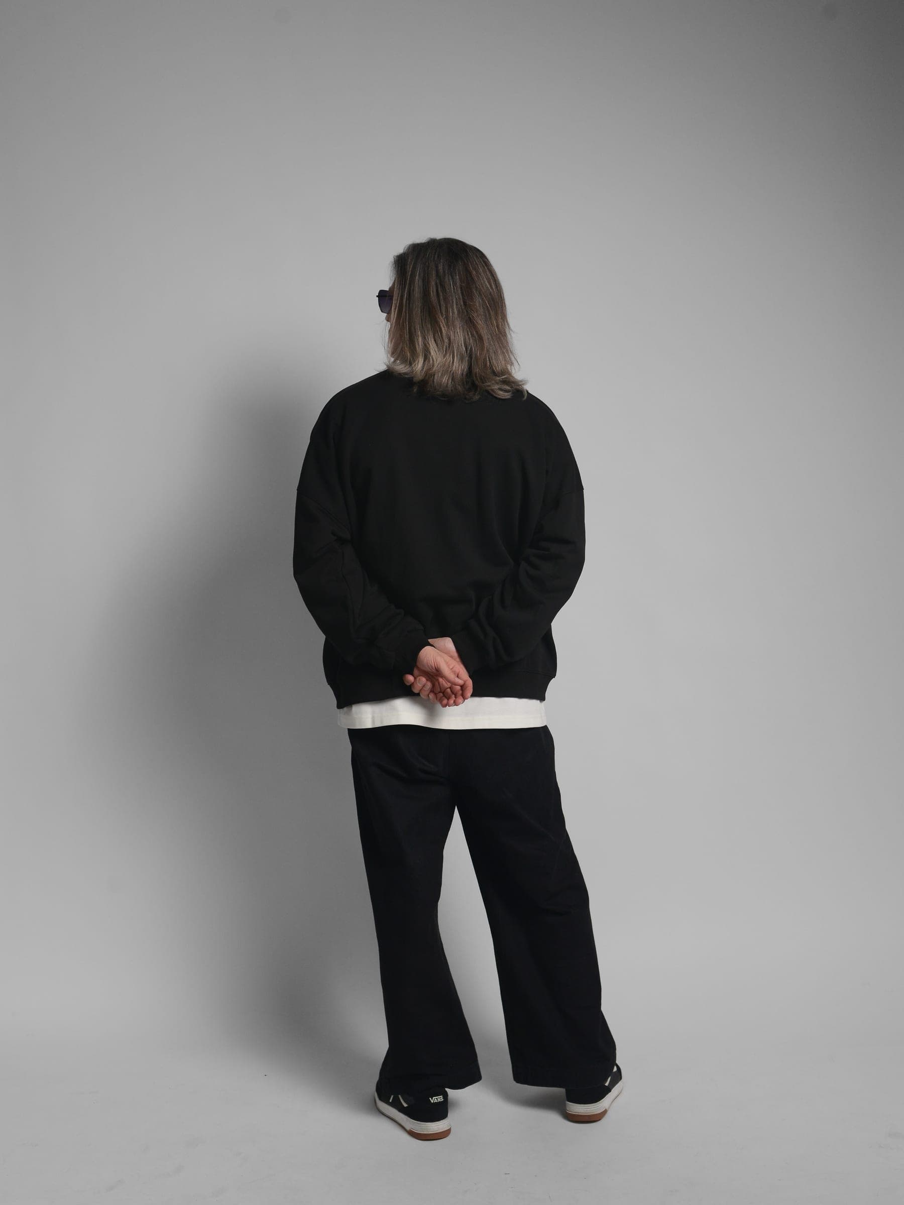 365.APParel Oversize Sweatshirt Black — man, full body back view, hands clasped, long silver hair, studio