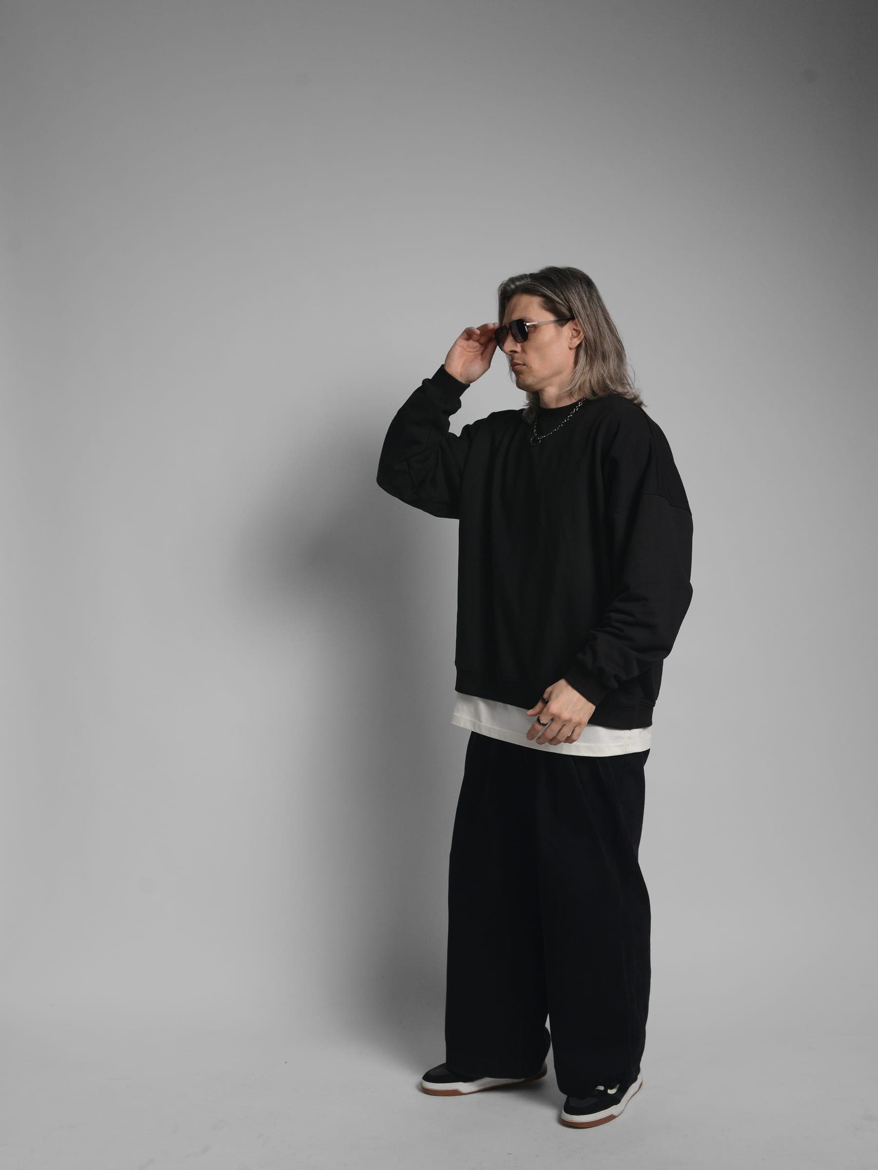 365.APParel Oversize Sweatshirt Black — man, full body side view, sunglasses, hand adjusting sunglasses, studio