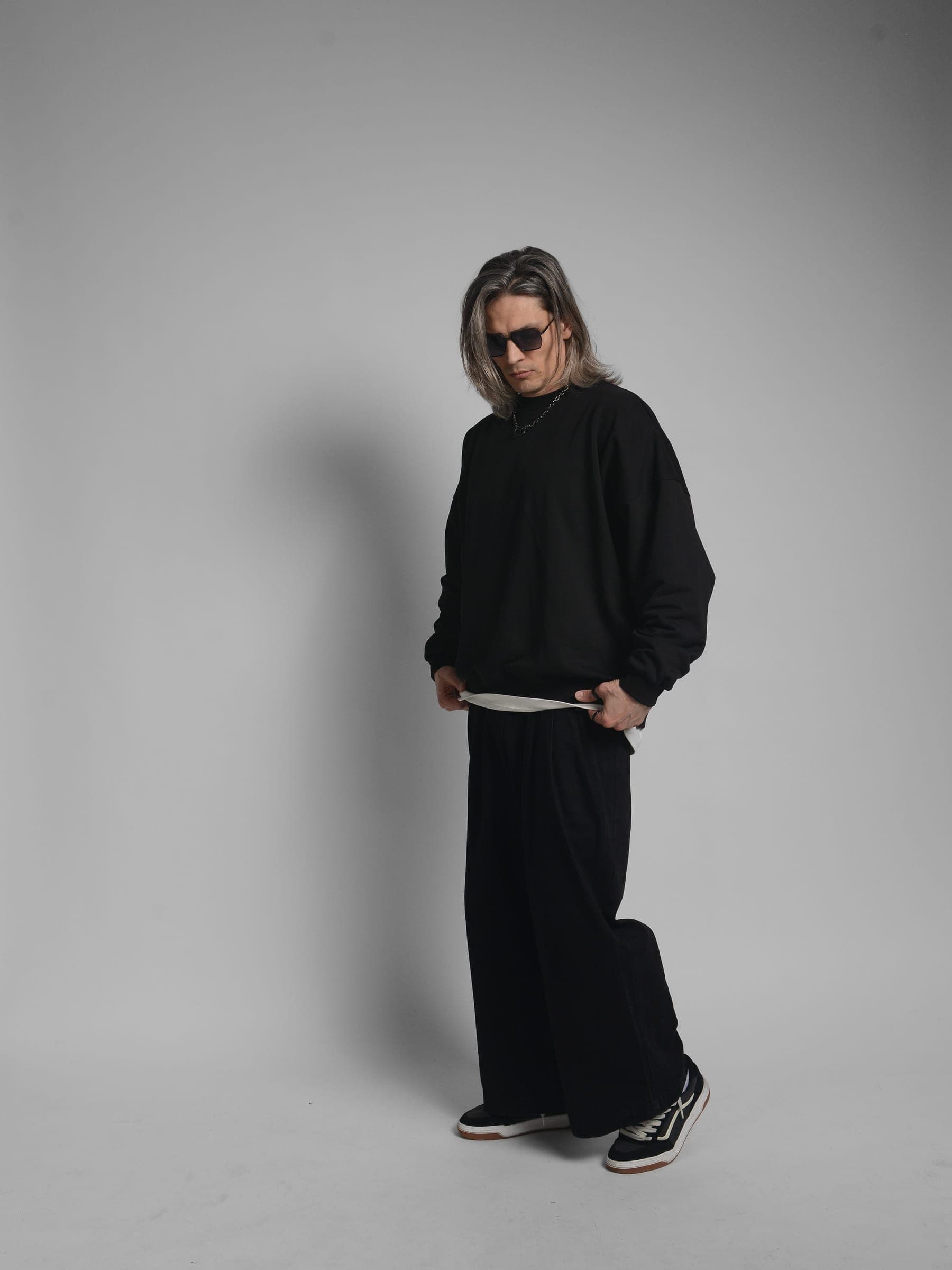 365.APParel Oversize Sweatshirt Black — man, full body three-quarter front view, sunglasses, looking down, long silver hair, studio
