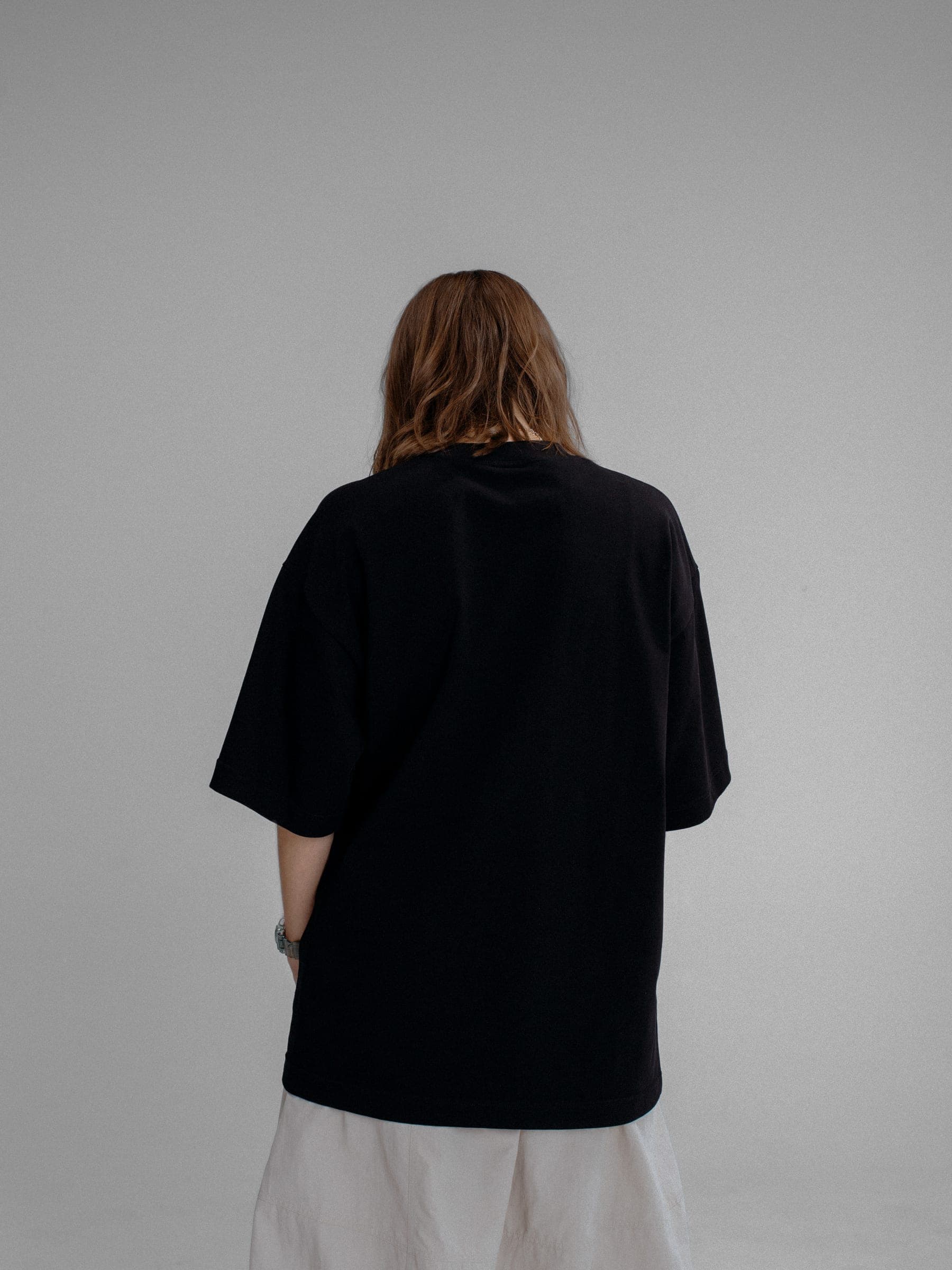 365.APParel Oversize T-shirt Black — woman, cropped back view, studio